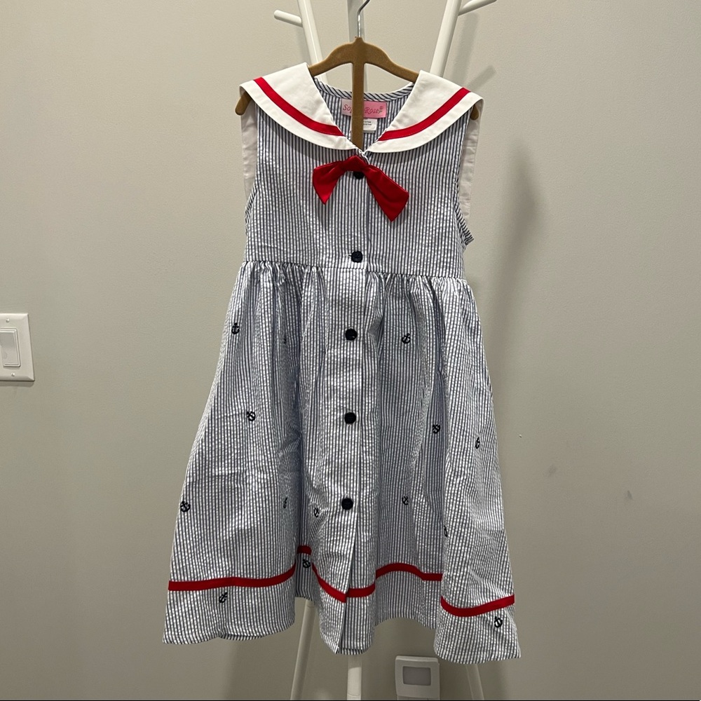 Girls seersucker sailor dress with embroidered anchor print and red detailing